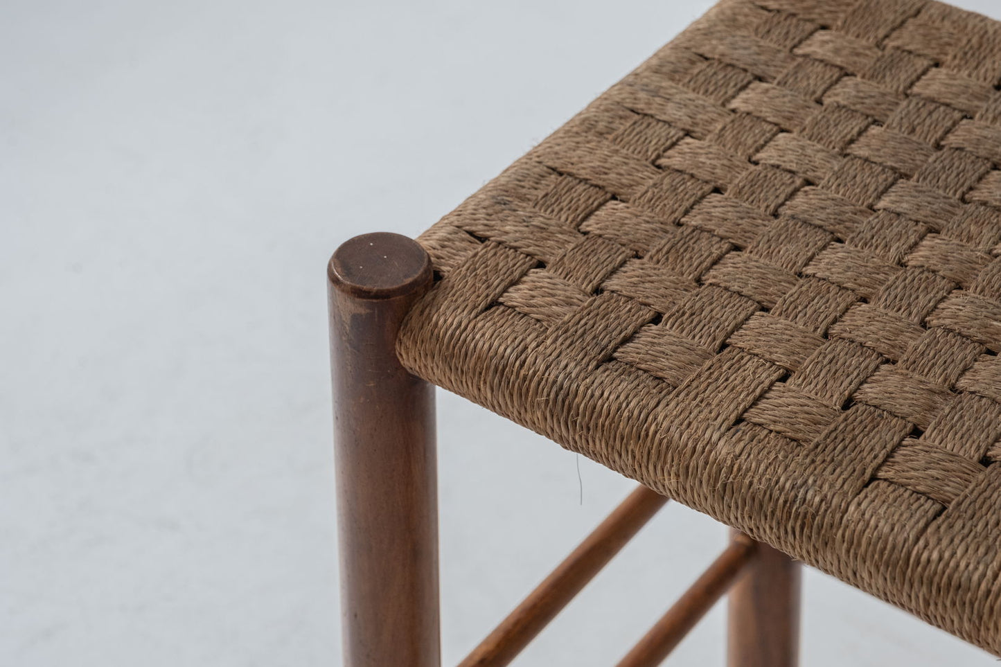 A charming set of two stools with papercord seats, crafted in France during the 1960s.