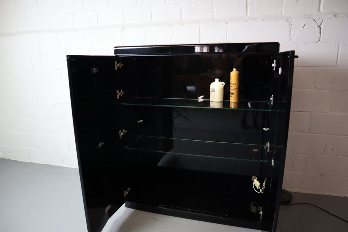Black lacquered bar cabinet with Travertine top